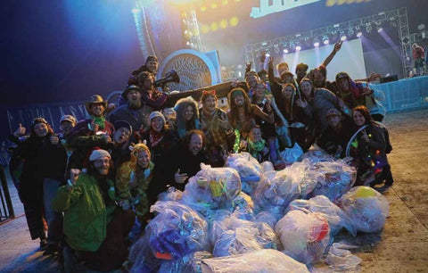 Electric Forest's Electricology team in front of trash pile