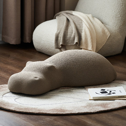 A hippo pouf placed in the living room. It has a cute shape and can be placed anywhere.