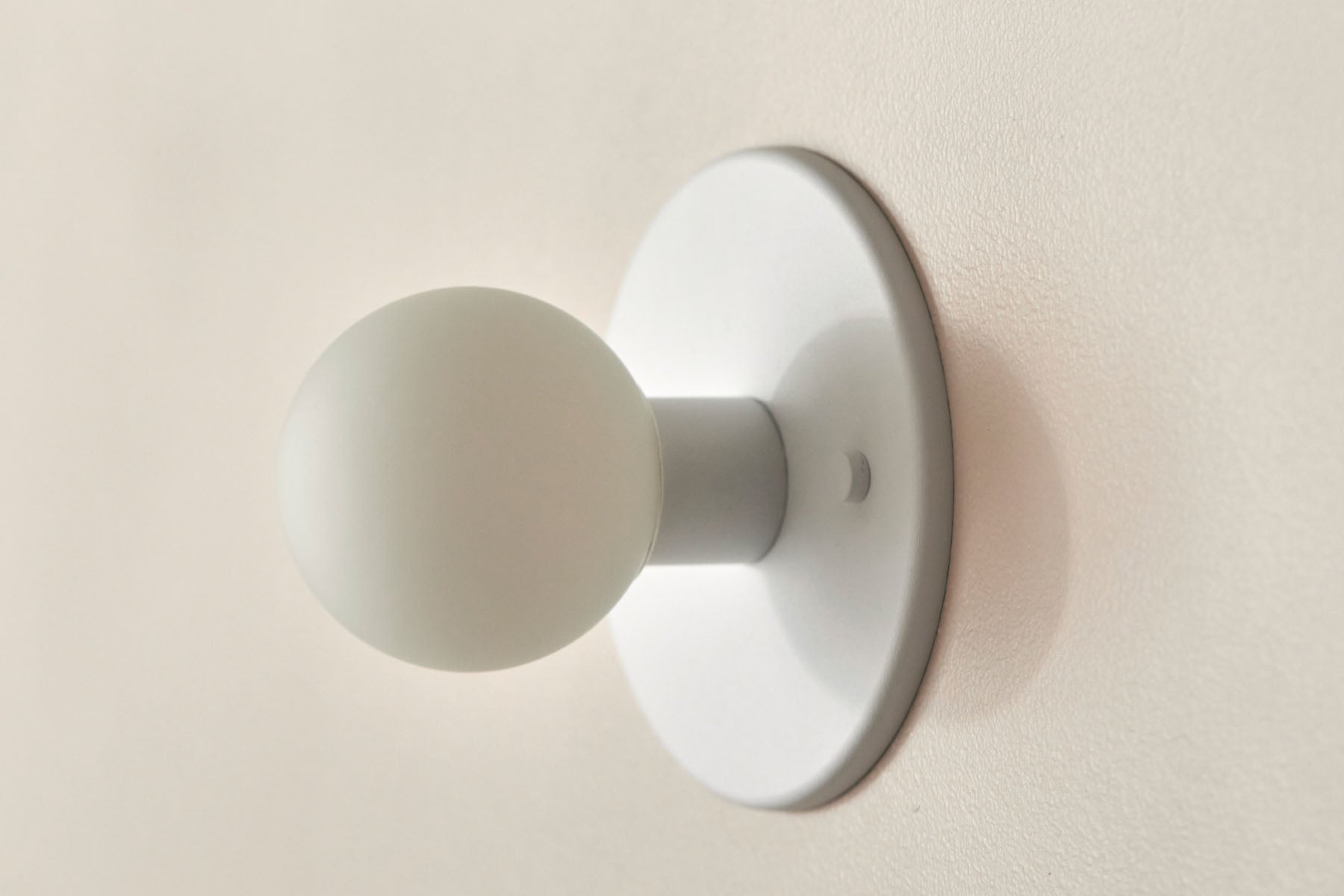 Orb Surface Sconce, Mini in White Satin and White Frosted. Image by Lawrence Furzey.