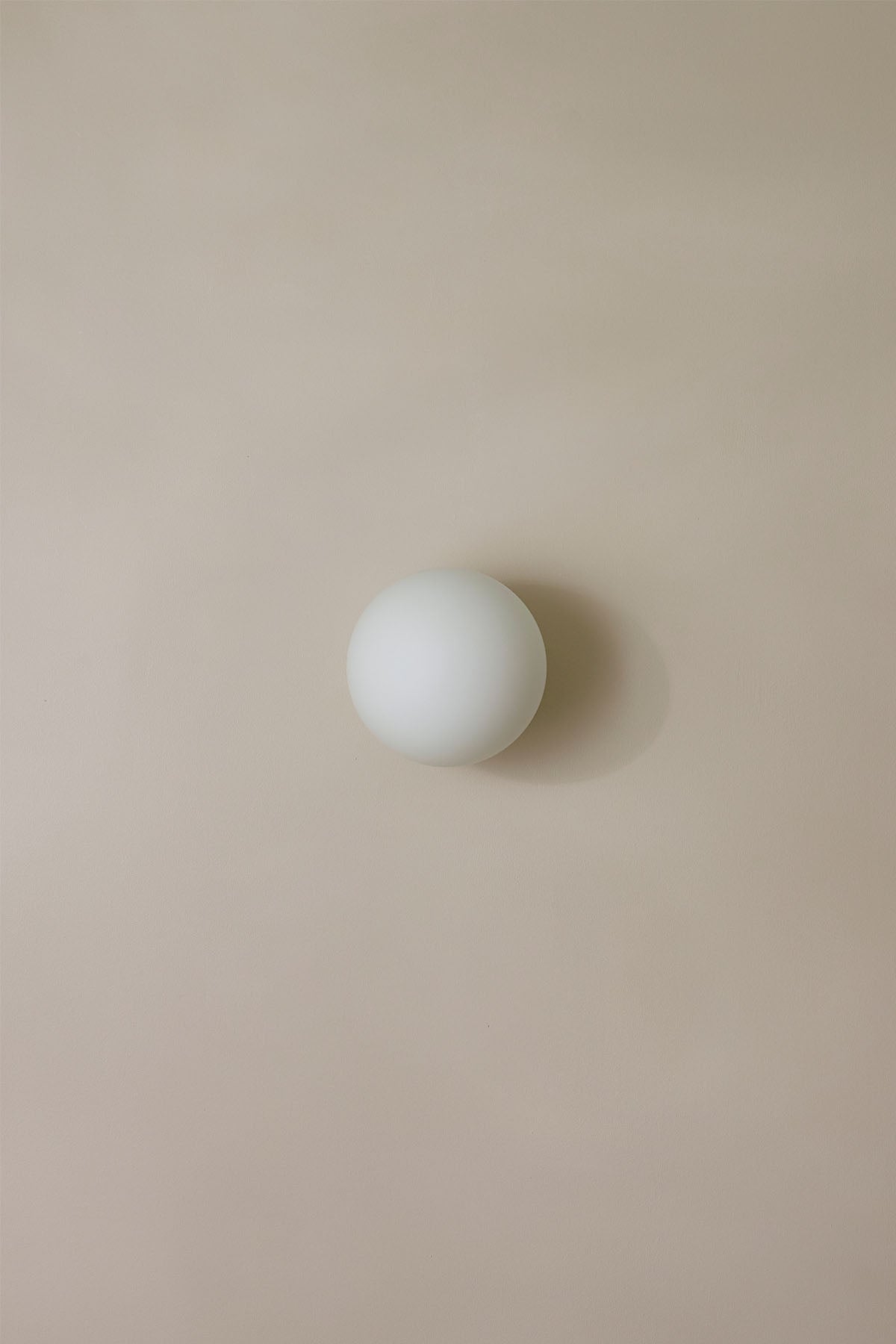 Orb Surface Sconce, Large in White Frosted. Image by Lawrence Furzey.