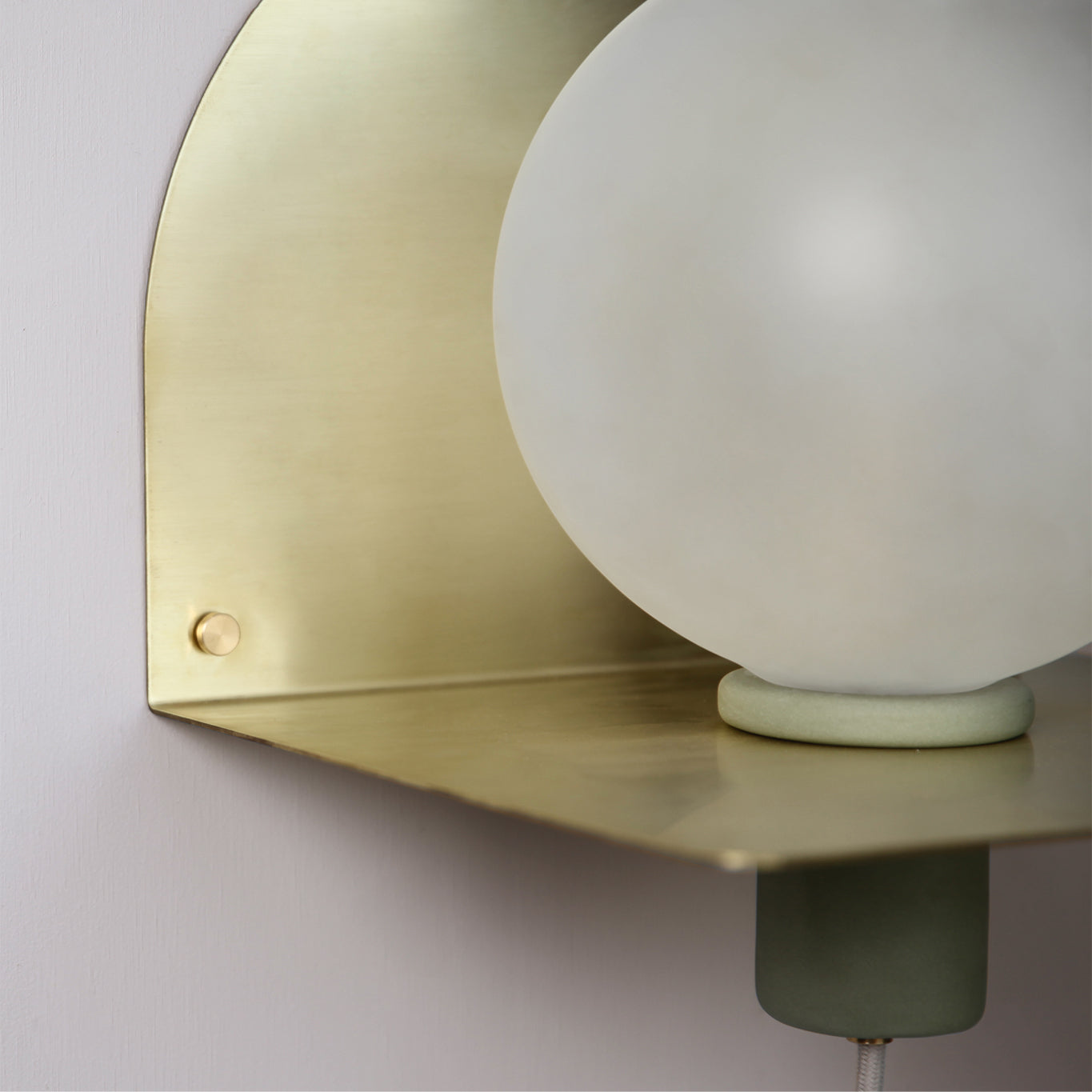 Close up detail of the Marz Designs Lune Wall Light in Brushed Brass/Sage.