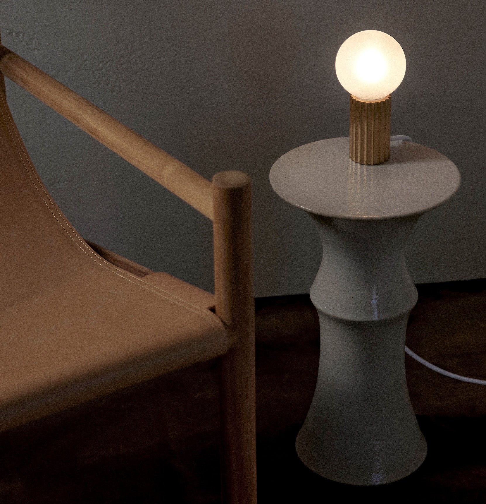 Marz Designs Attalos Table Lamp 95 on a ceramic plinth.
