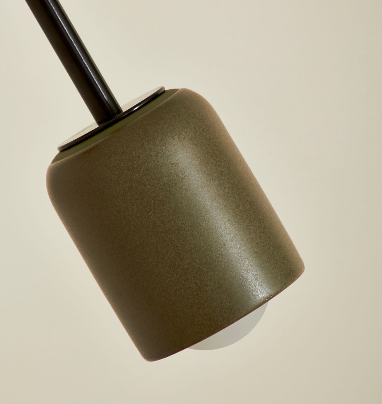 Close up of Marz Designs Terra 1 Long Articulating Wall Light in Olive/Brushed Black.