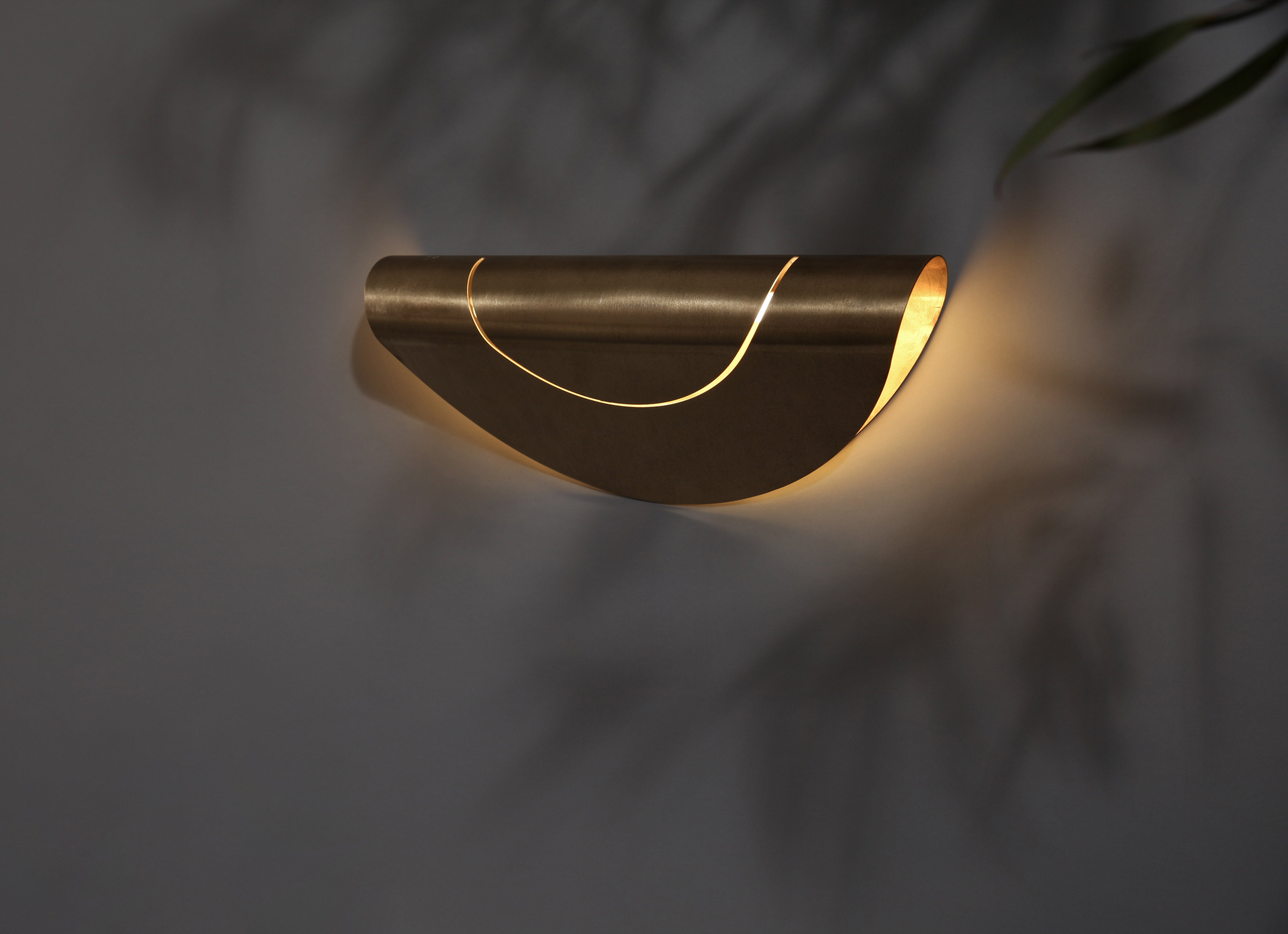 Marz Designs Feature Lighting - Horizontal Furl Circle Wall Light in Natural Brass.