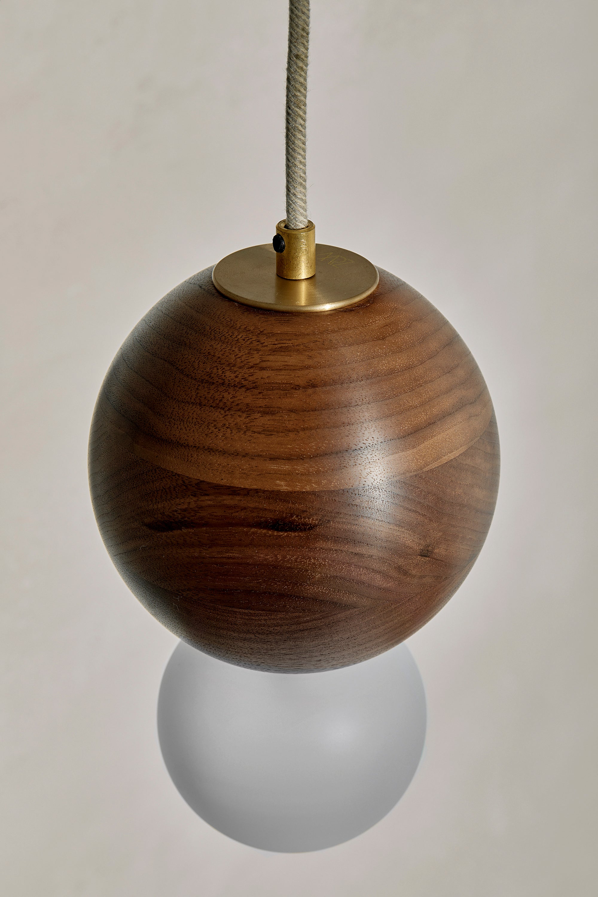 Bright Beads Sphere Pendant in Walnut & Brass. Photographed by Lawrence Furzey.