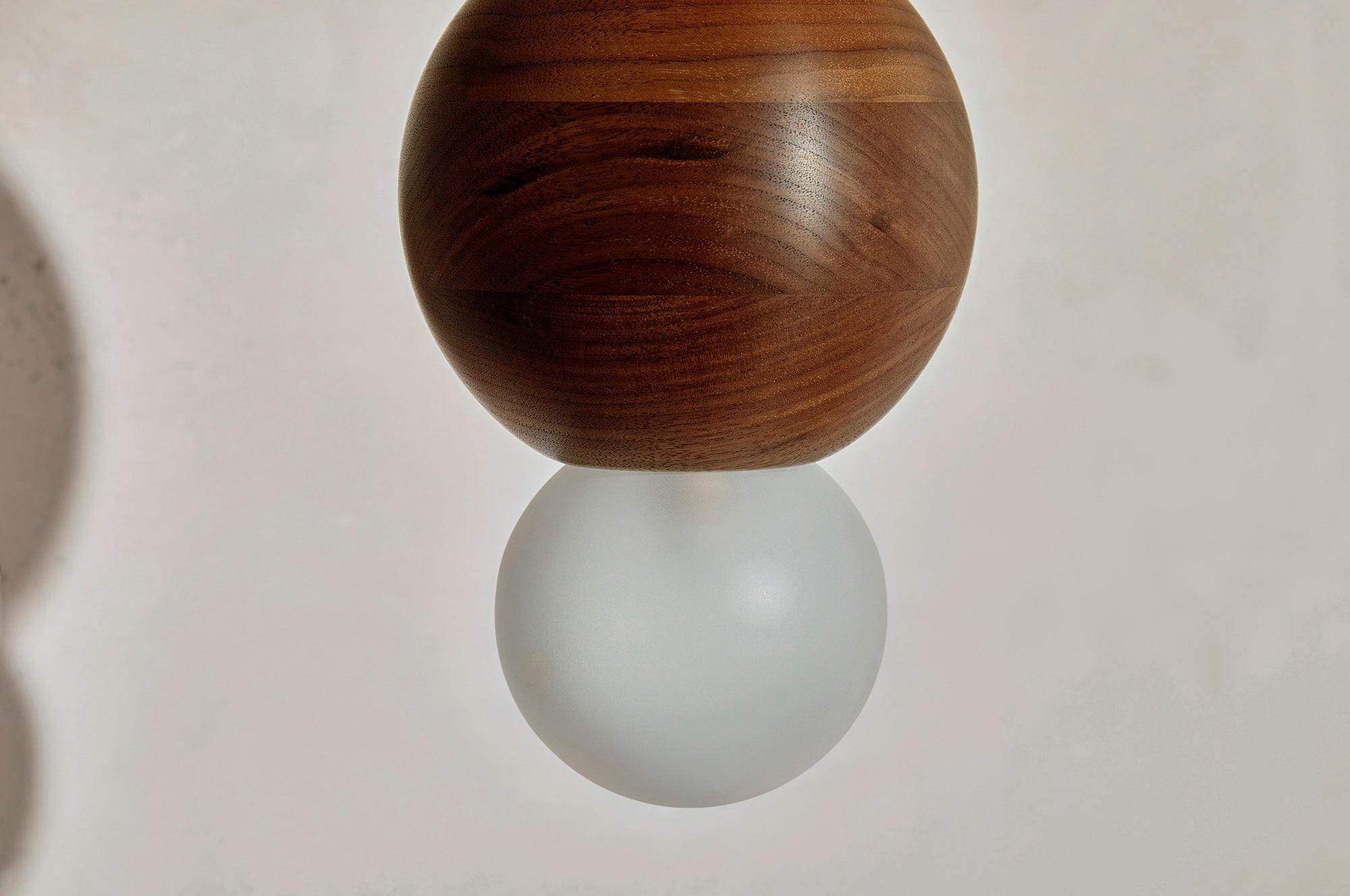 Detail of the Marz Designs Bright Beads Sphere Pendant Light w/ Solid Rod in Brass/Walnut.