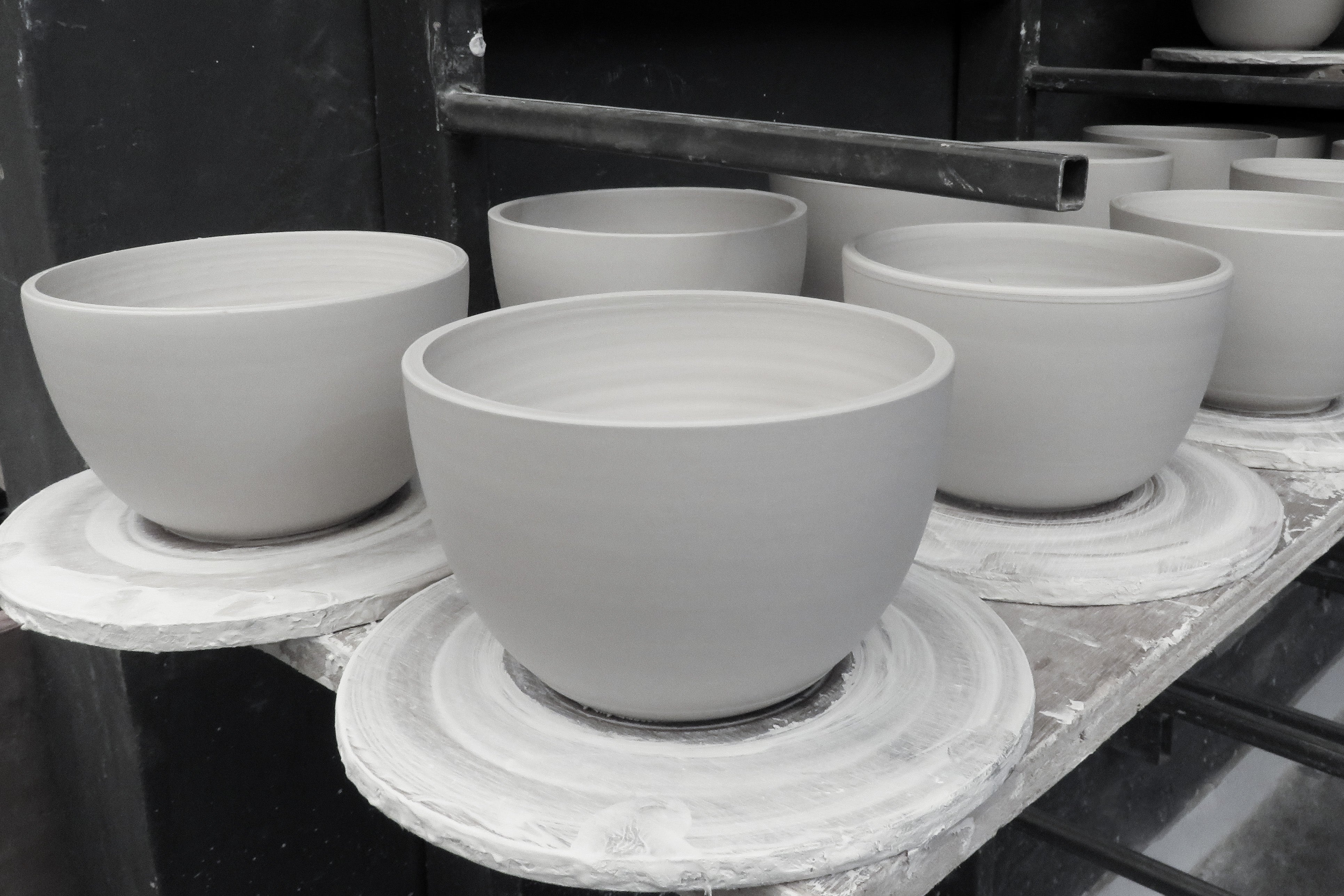 Our handmade clay ceramic shades in various stages of production. Photo supplied by Gaya ceramics.