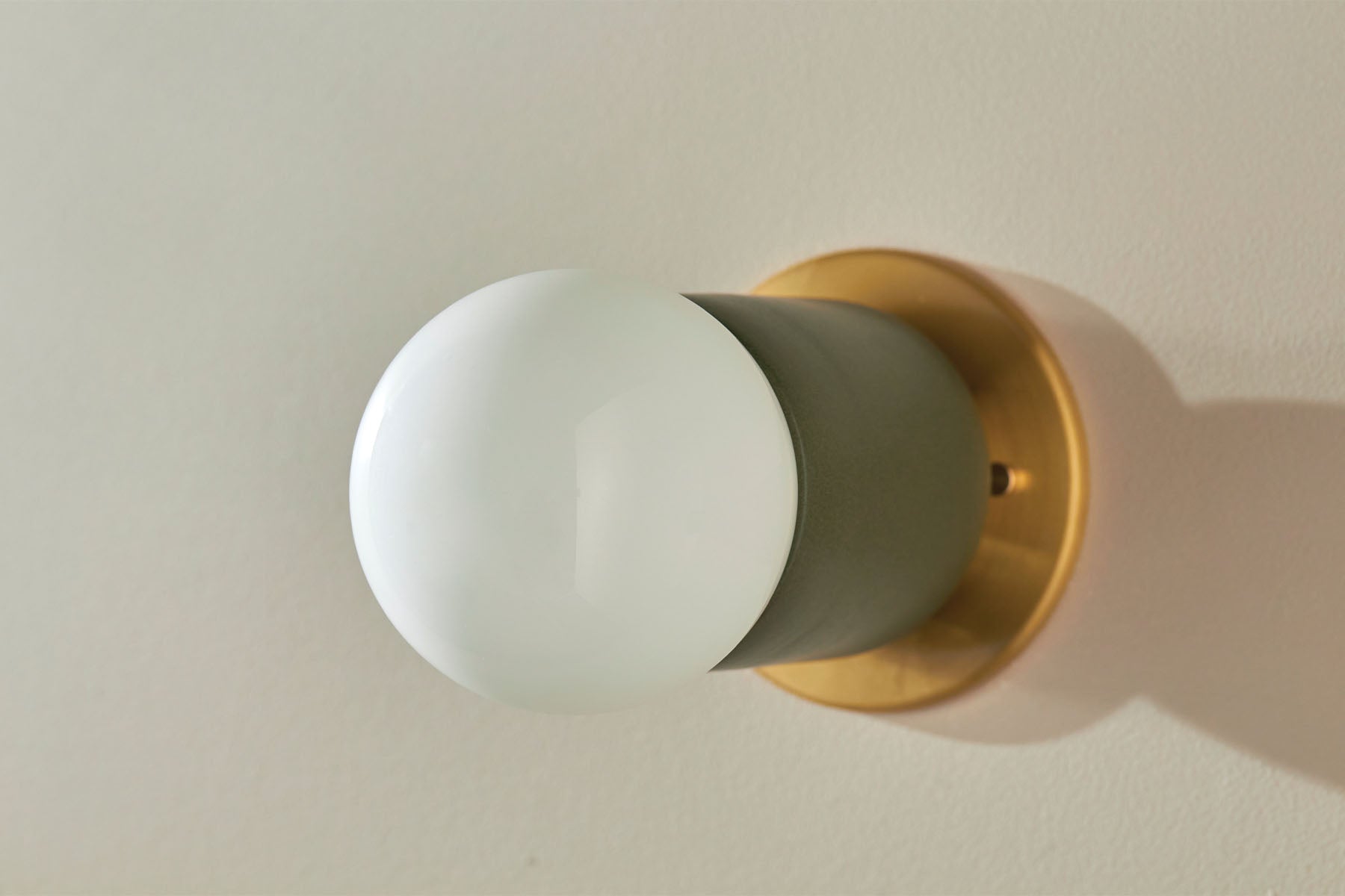 Terra 1 Surface Sconce, Slim Base Adapter in Olive and Brass. Image by Lawrence Furzey.