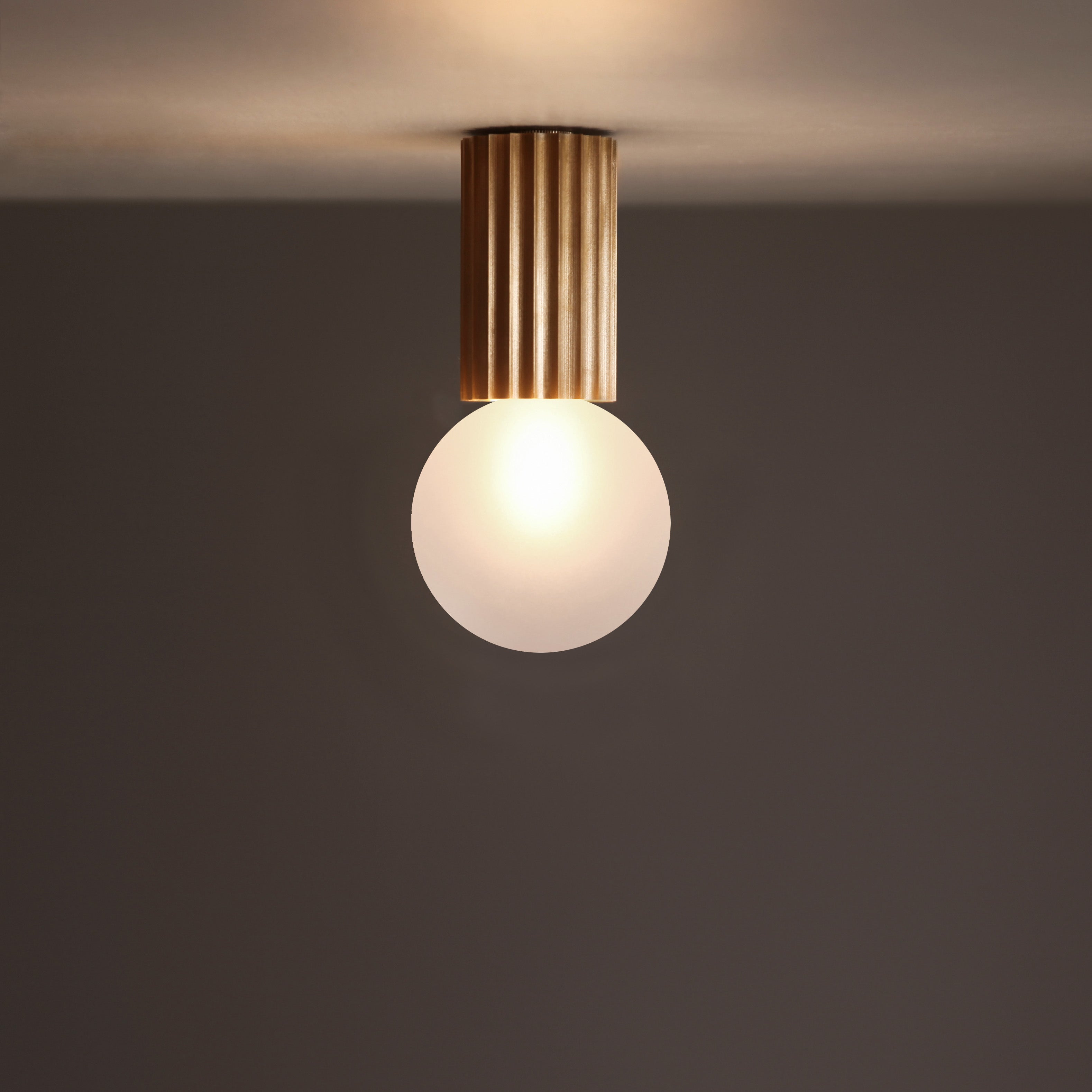 Marz Designs Attalos Ceiling Light with the bulb on.