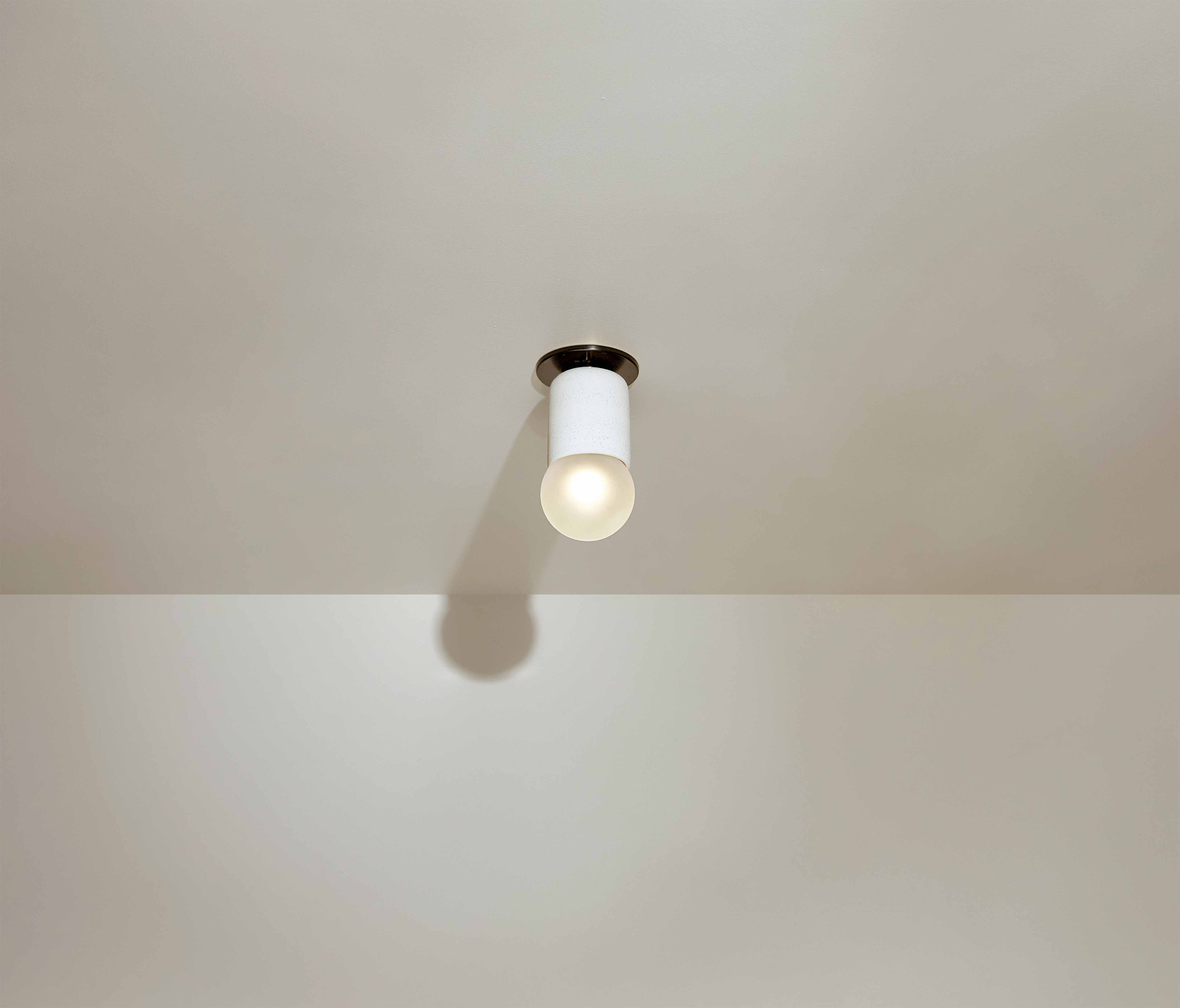 Marz Designs Terra 1 Surface Sconce with Slim Base Adapter in Vanilla Bean and Brushed Black.