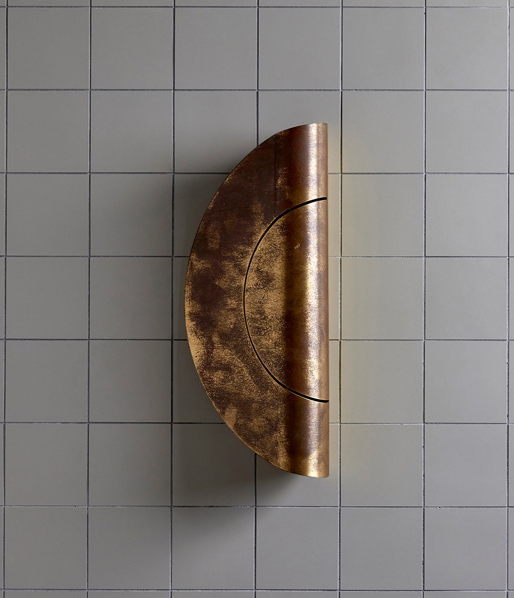 Furl Circle Wall Light, Natural Brass Patina after 2 plus years and exposure to the elements.