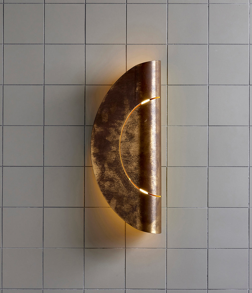 Furl Circle Wall Light, Natural Brass Patina after 2 plus years and exposure to the elements.