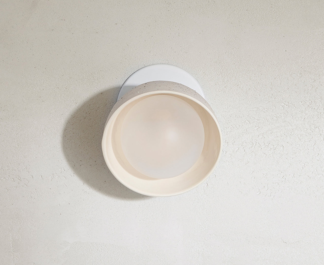 Close up of Marz Designs Terra 0 Short Articulating Surface Sconce in Vanilla Bean/White Satin.