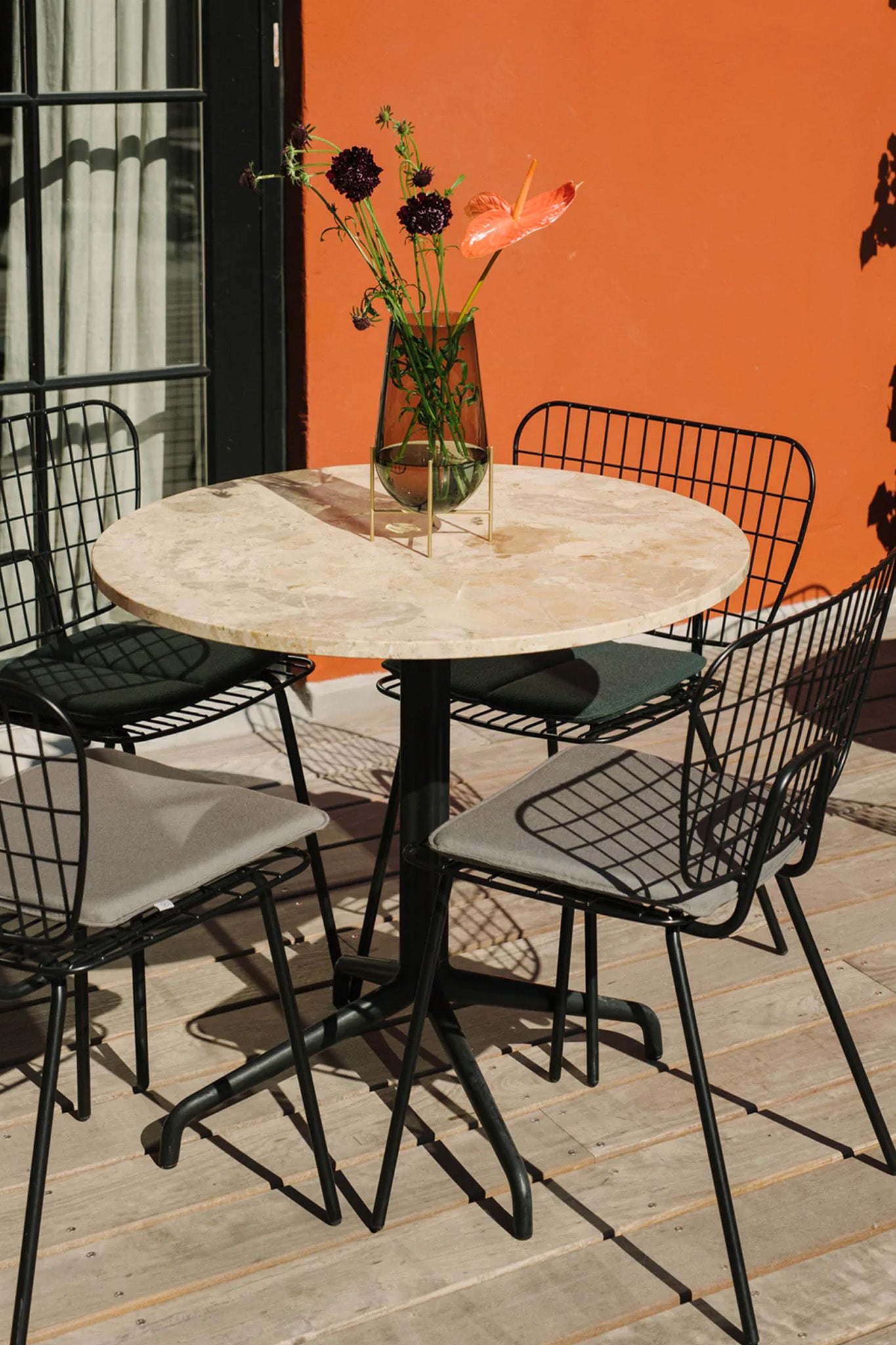 Harbour Column Dining Table, Round With Star Base in White Marble . Image by Menu