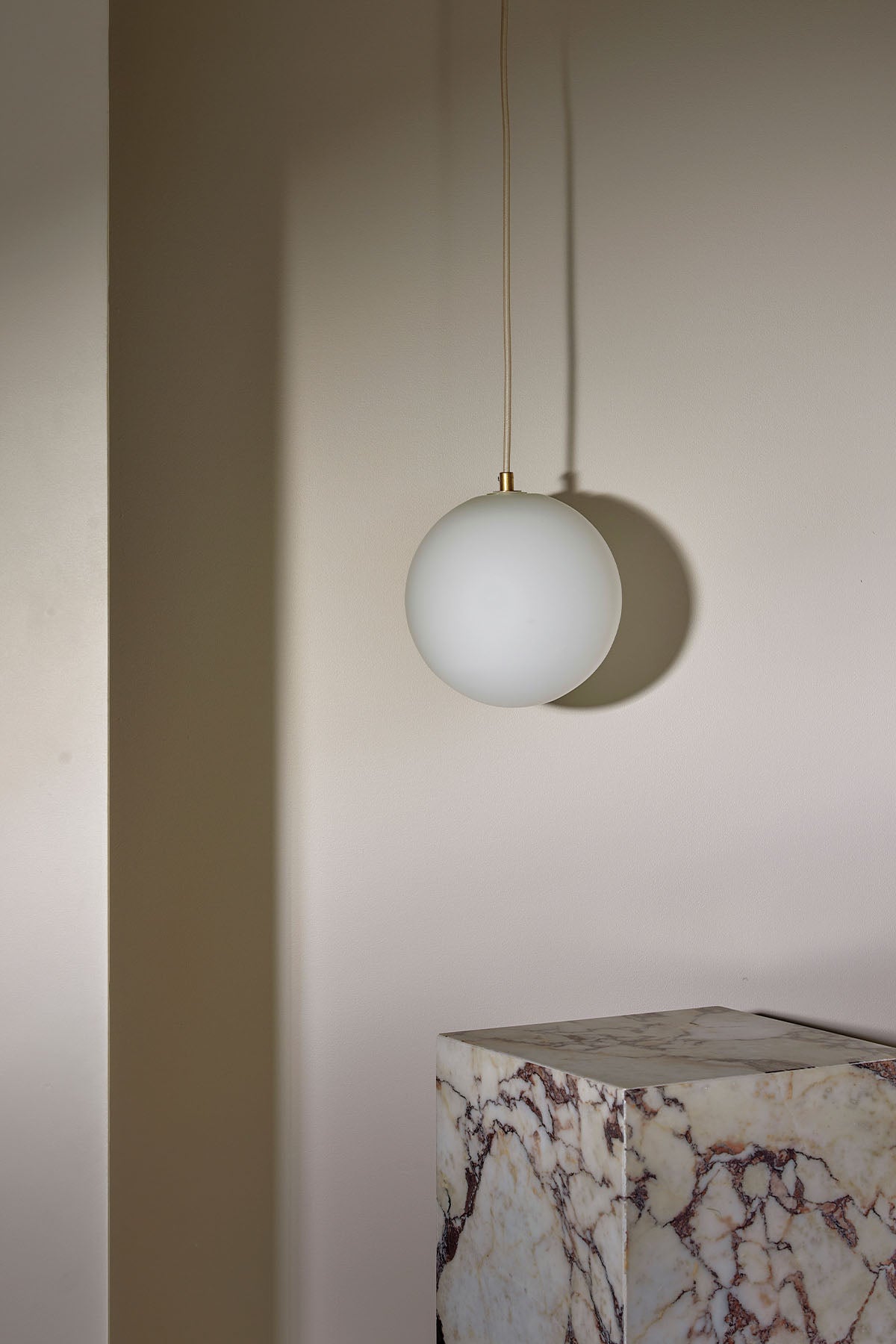 Orb Pendant, Large in Brass and White Frosted. Image by Lawrence Furzey