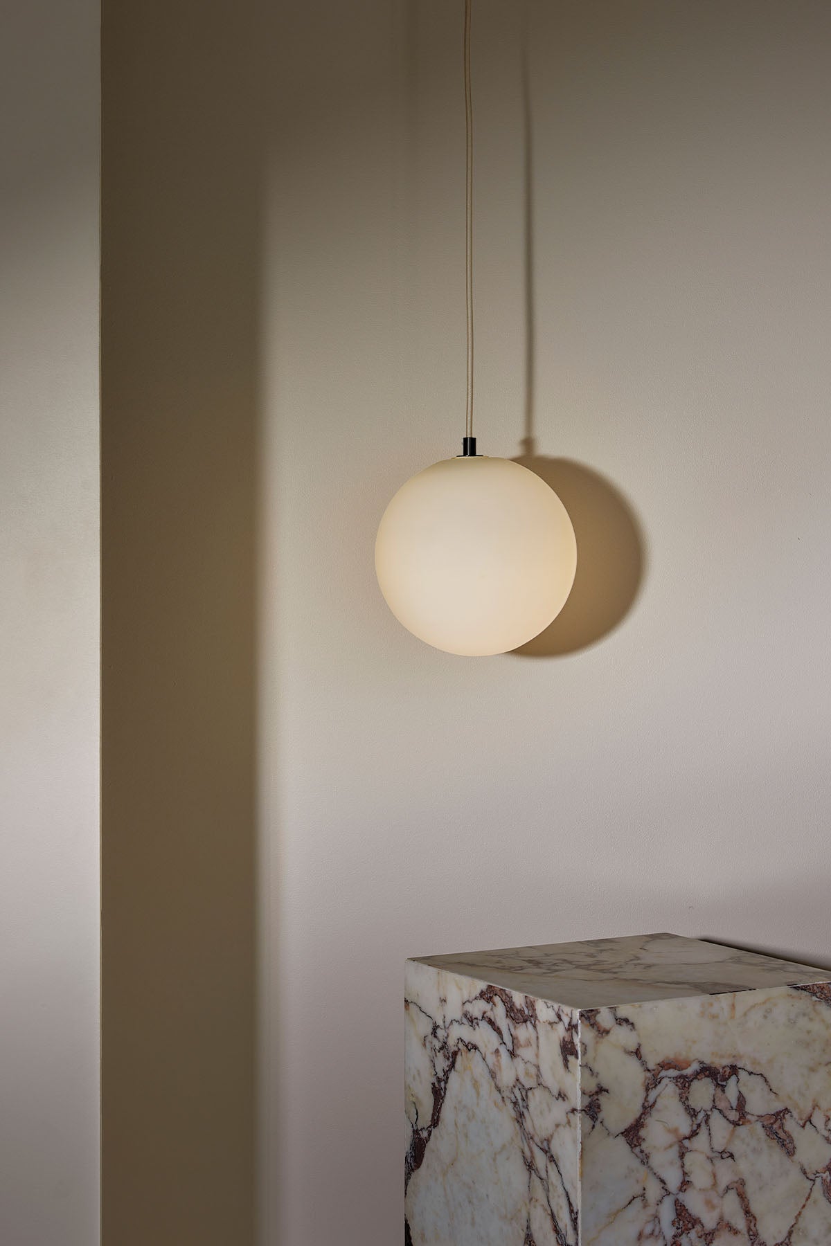 Orb Pendant, Large in Brushed Black and White Frosted. Image by Lawrence Furzey