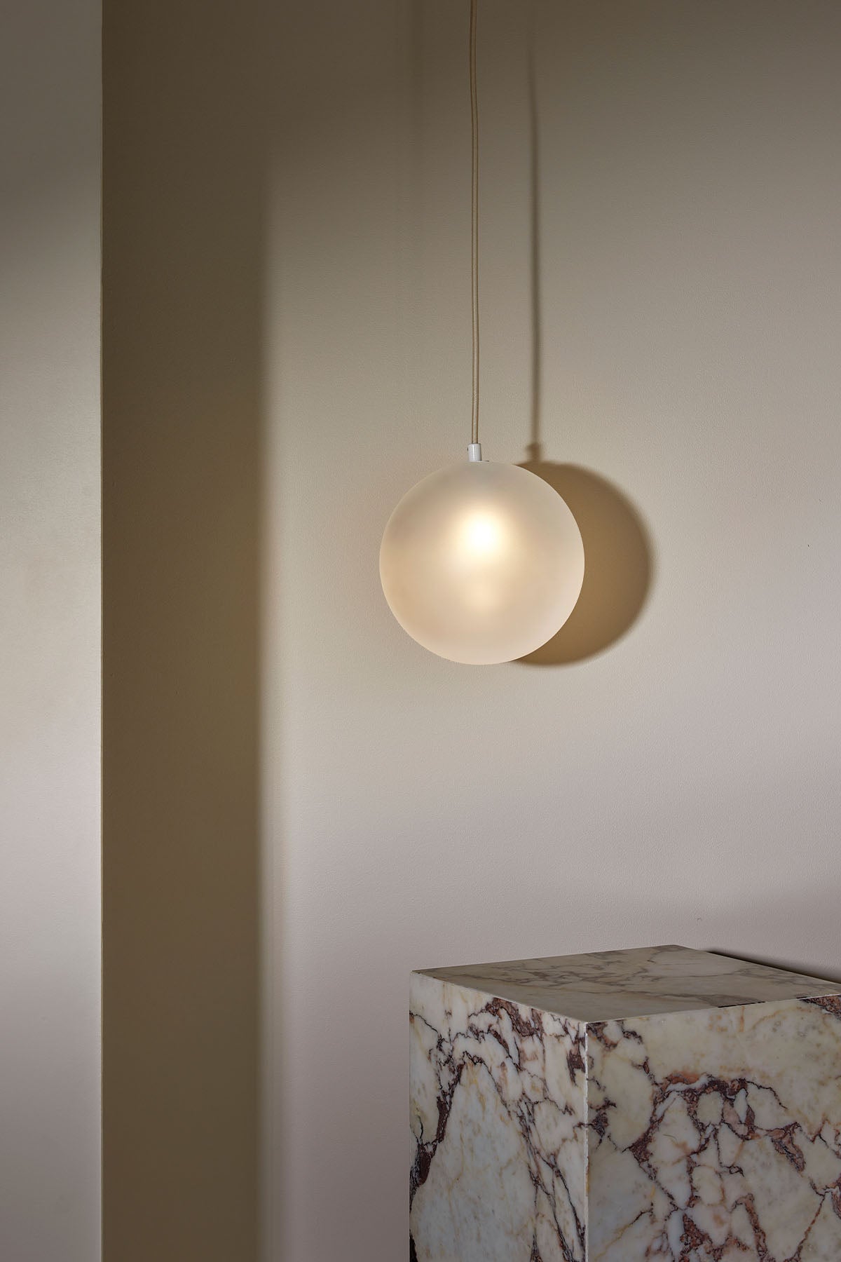 Orb Pendant, Large in Brass and Clear Frosted. Image by Lawrence Furzey