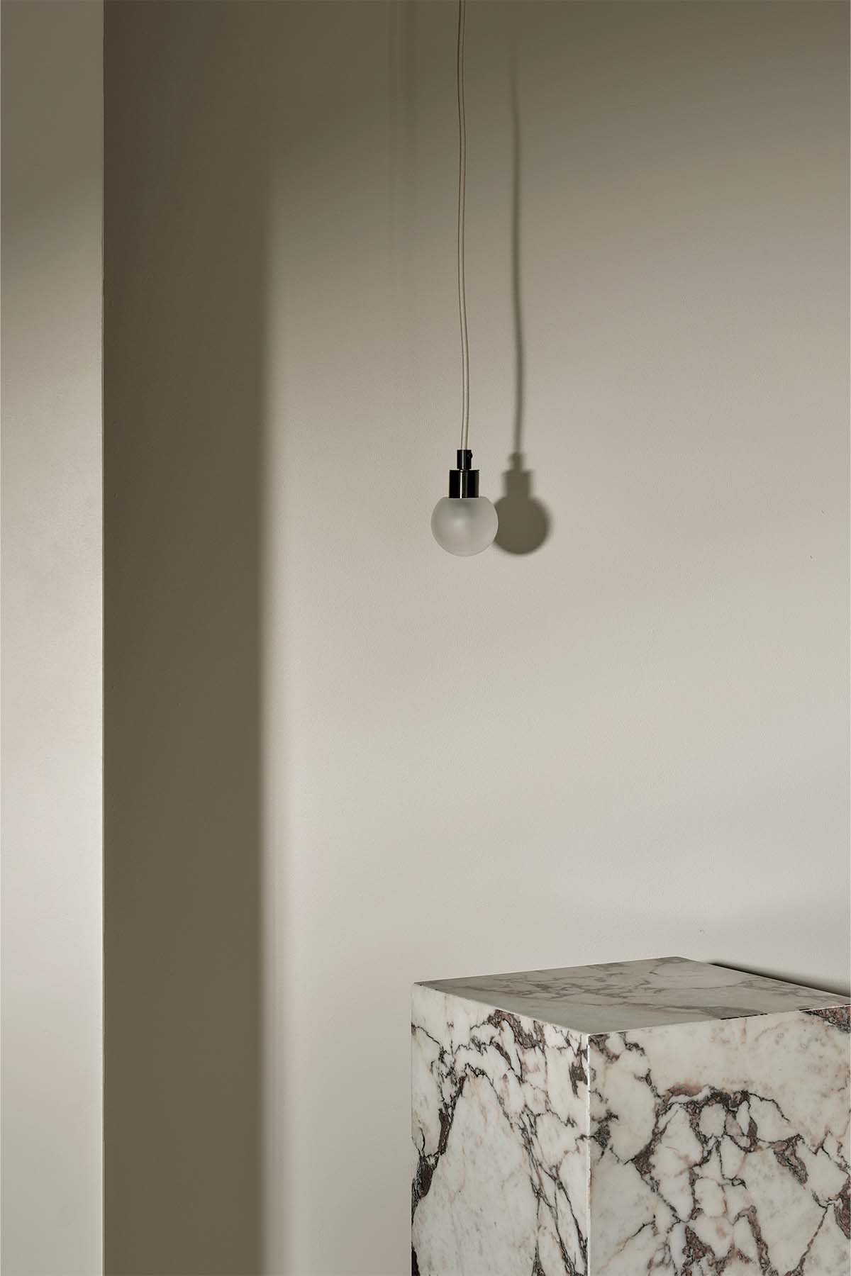 Orb Pendant, Mini in Brushed Black and Clear Frosted. Image by Lawrence Furzey
