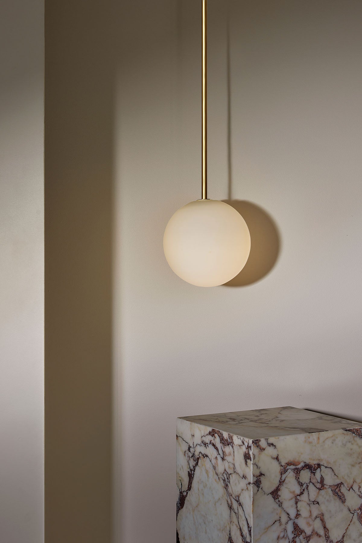 Orb Pendant, Large in Brass and White Frosted. Image by Lawrence Furzey