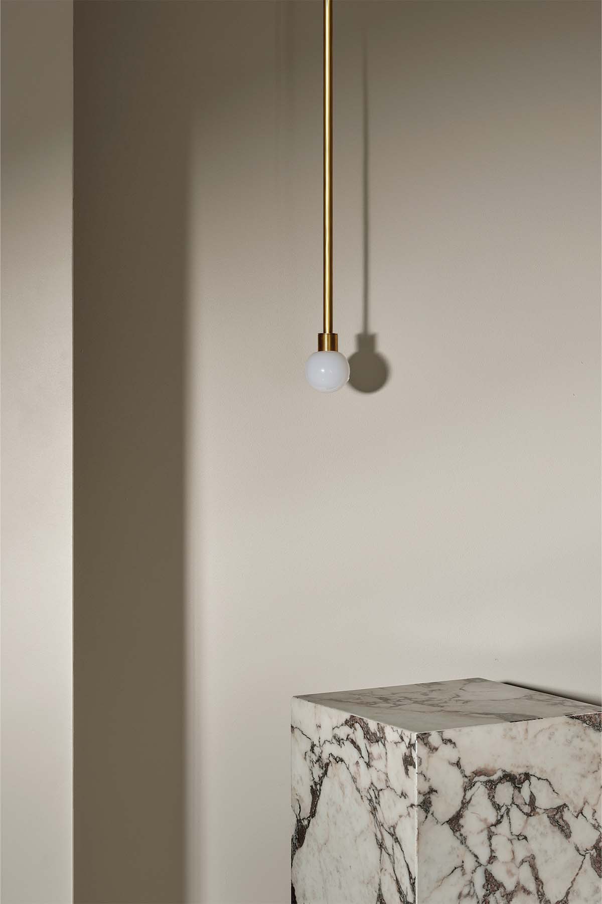 Orb Pendant, Mini in Brass and Opal. Image by Lawrence Furzey