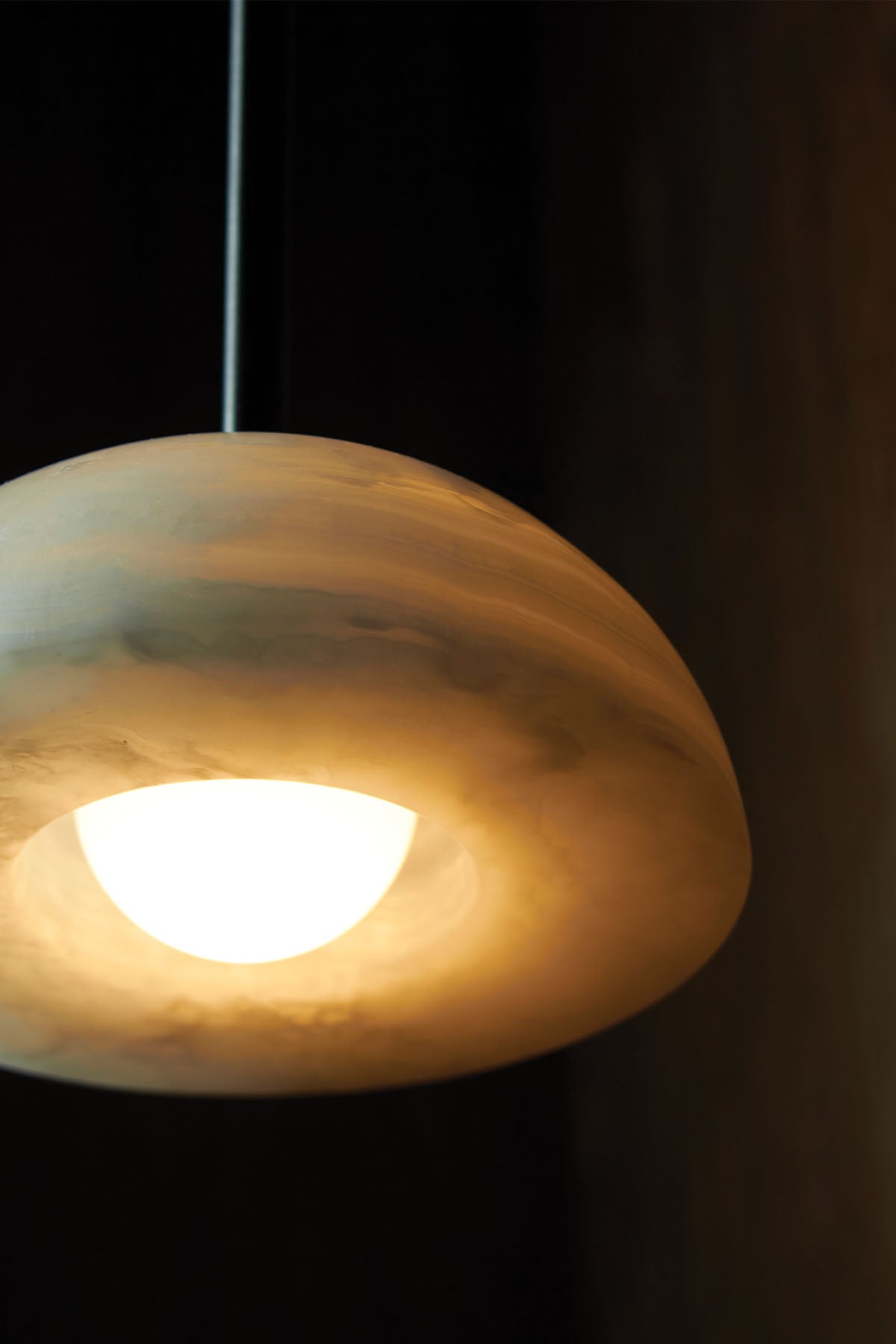 Aurelia Pendant Light, in White Onyx and Brushed Black. Image by Lawrence Furzey.