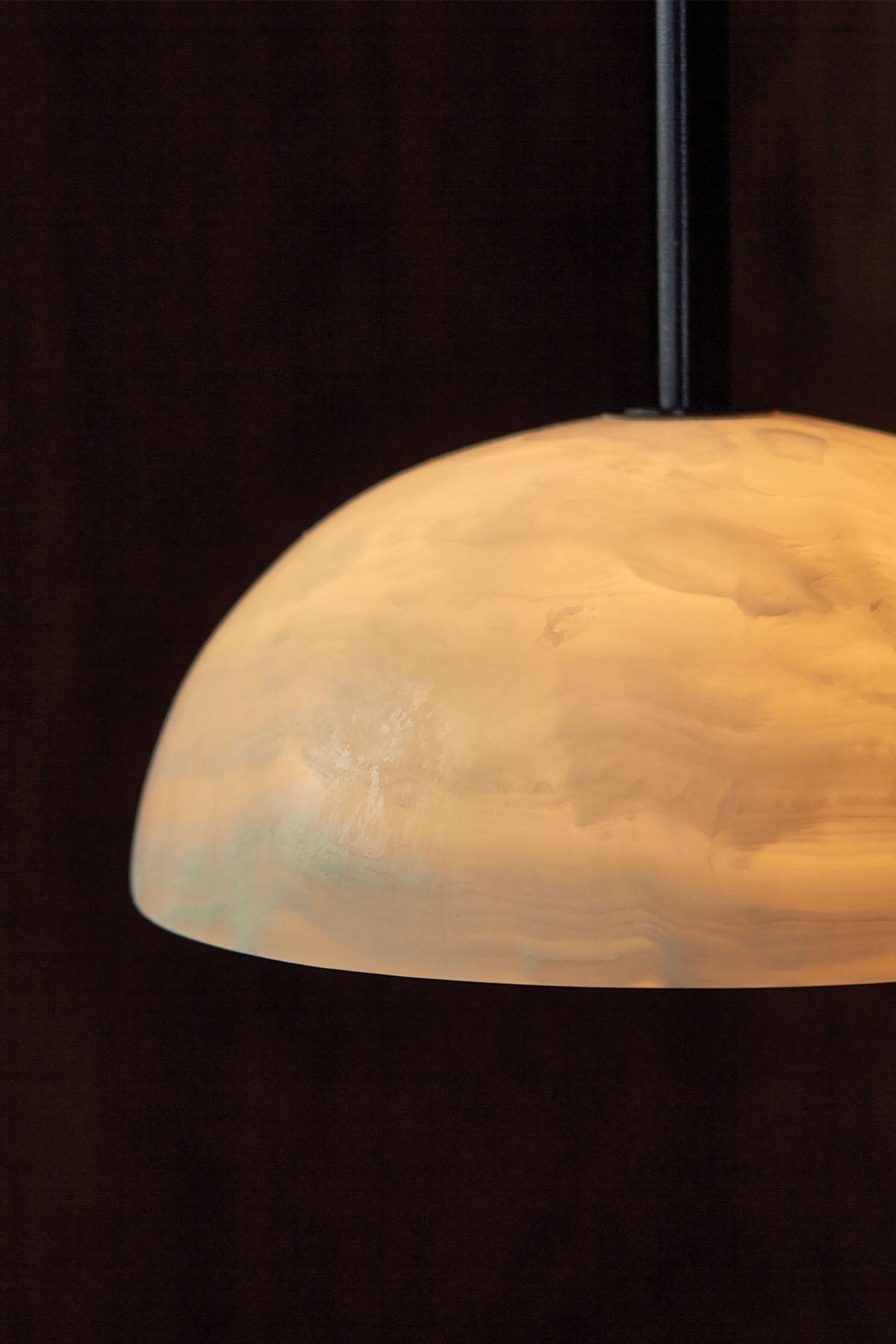 Aurelia Pendant Light, in White Onyx and Brushed Black. Image by Lawrence Furzey.