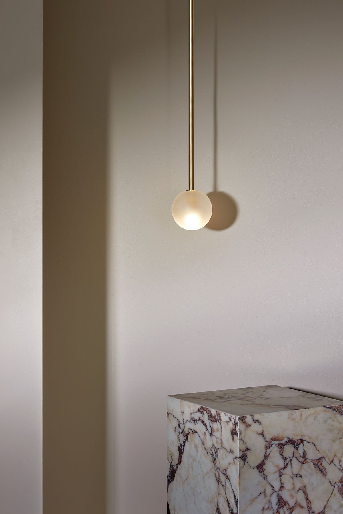 Orb Small Pendant, Solid Rod in Brass and Clear Frosted. Image by Lawrence Furzey