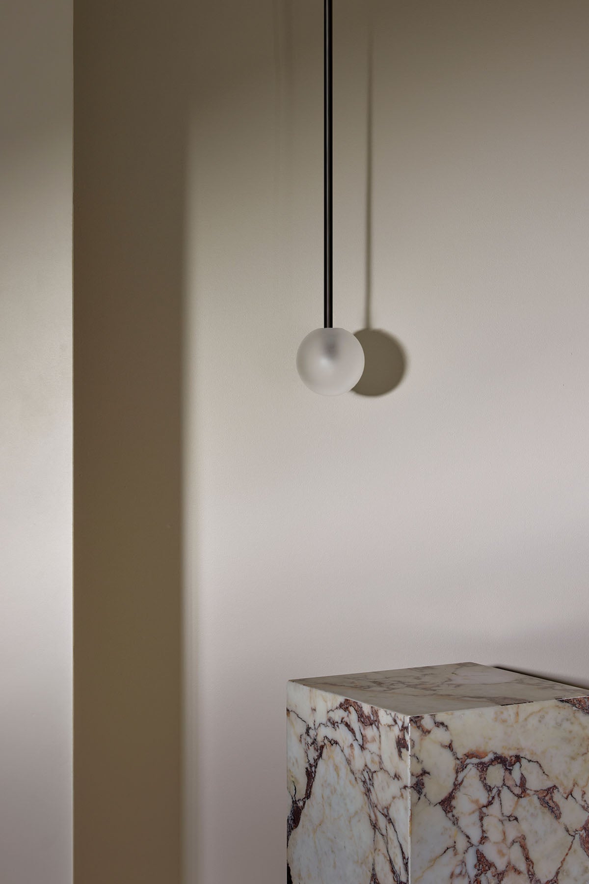 Orb Small Pendant, Solid Rod in Brushed Black and Clear Frosted. Image by Lawrence Furzey