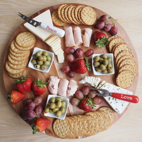 full charcuterie board with dishes and utensils