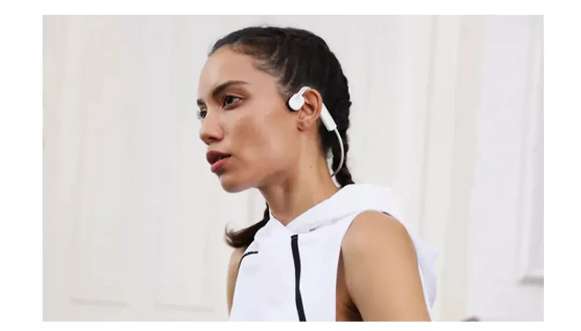 a people is wearing bone conduction headphones