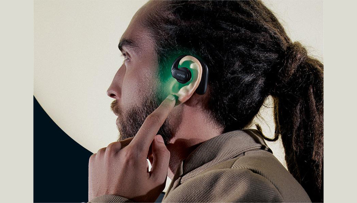 A man is wearing bone conduction headphones