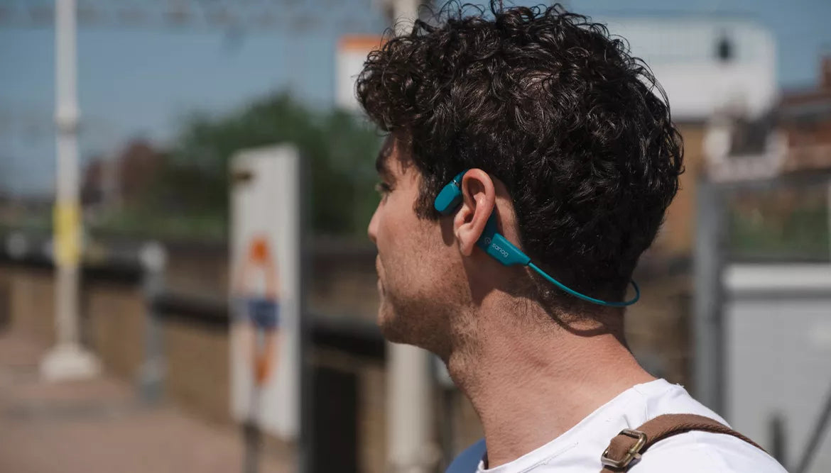A men wears bone conduction headphones