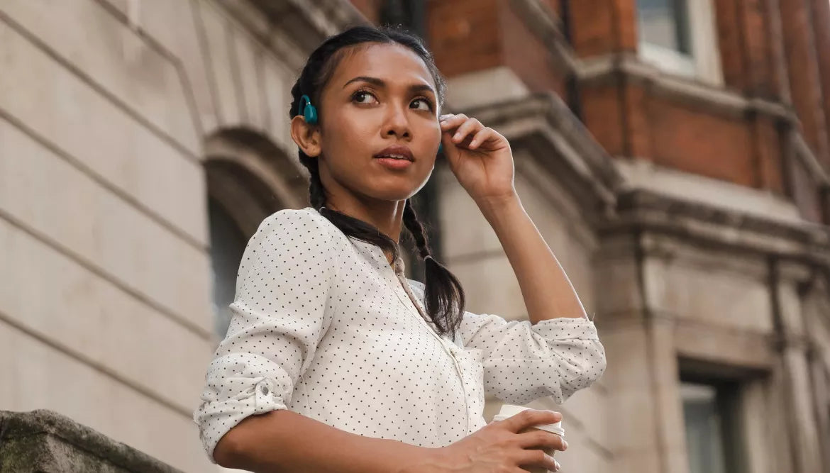 A women wears bone conduction headphones