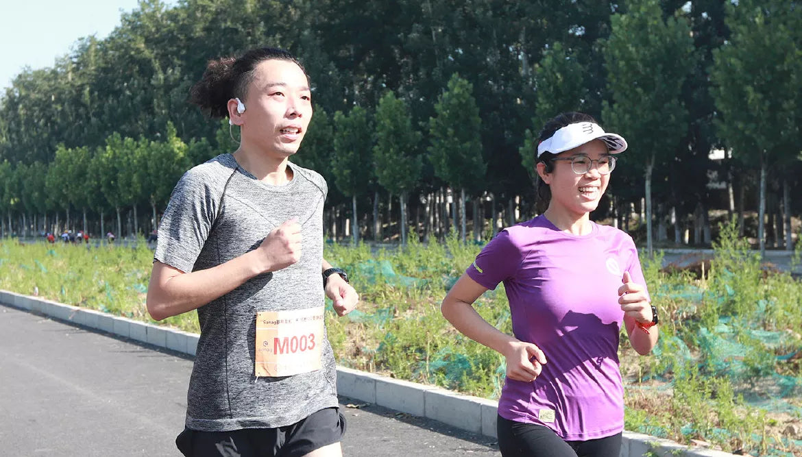 Runners wear open ear sports bone conduction headphones
