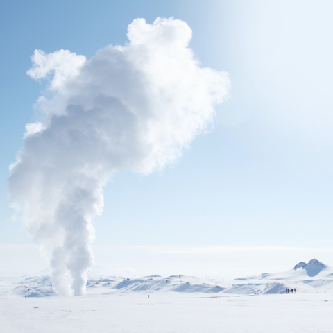 Image of a smoke rising from snow-covered field