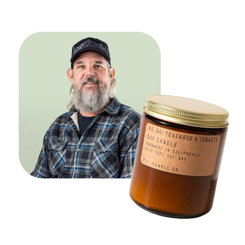 Image of EarthHero team member Russ next to a PF candle in an amber glass jar