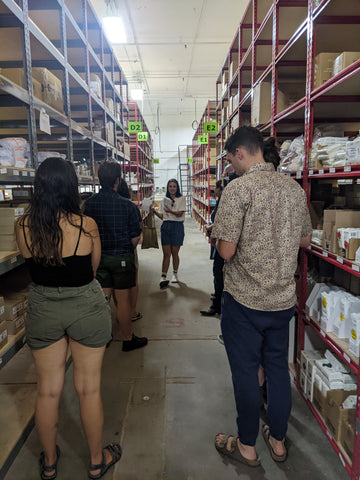 Photo of people in EarthHero's warehouse following the guided tour