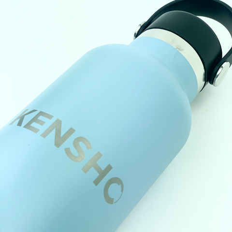 Image of a Hydro Flask water bottle with a company logo engraved on it.