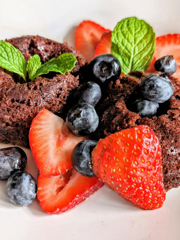 chocolate mini cakes infused with dhol chai spice tea with fresh strawberries, blueberries, mint leaves drizzled with a strawberry rhubarb vinaigrette