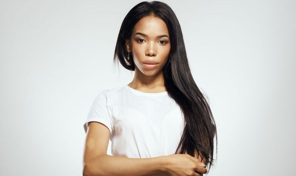 black woman with hair extensions and white shirt