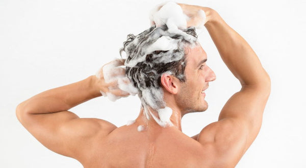 man washing hair system in malaga