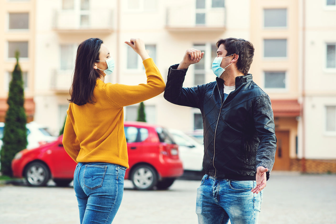 Two people practicing social distancing