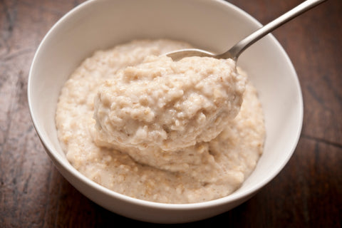 A bowl of traditional Scottish porridge being spooned out