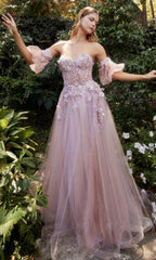 Image of woman standing in a garden wearing a pastel ball gown with removable puff sleeves.