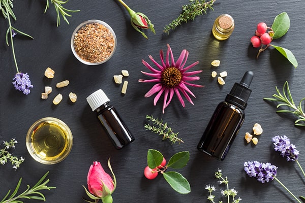 A person blending myrrh essential oil with other essential oils - Uncover the harmonious synergy of Myrrh Oil Benefits for 2023 and Beyond in this insightful post by MDBiowellness- Plant Medicine. Developed by Doctors.