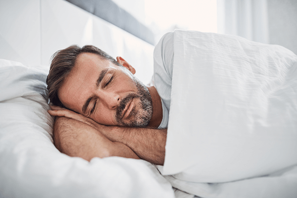 What Does CBN Do? Developed by Doctors': A depiction of a person sleeping soundly with a bottle of CBN oil positioned nearby, highlighting the potential relationship between CBN and its effects on sleep within the guide developed by doctors.