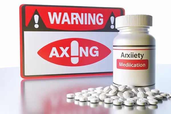 Bottle of Xanax pills and a warning sign