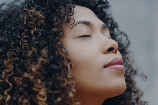 Person engaging in mindfulness meditation for better sleep