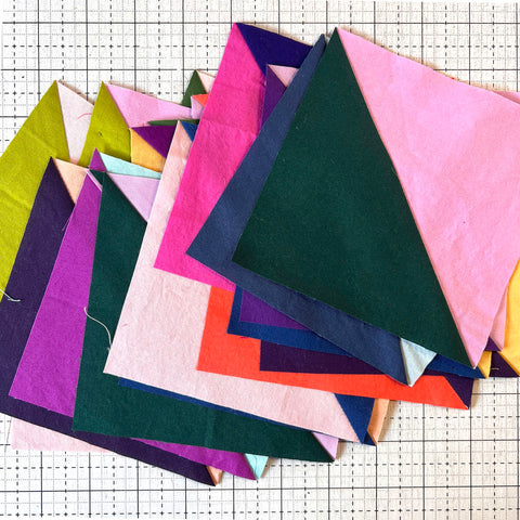 pile of colorful quilt blocks