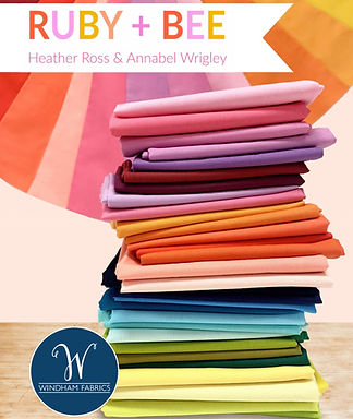 Stack of Ruby + Bee solid fabrics from Windham Fabrics